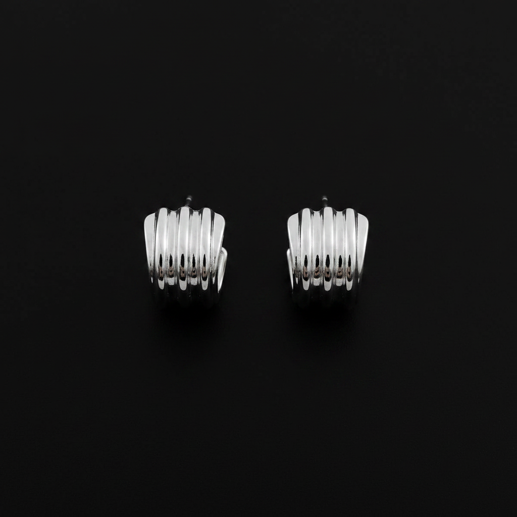 Black background chunky ribbed silver huggie hoops