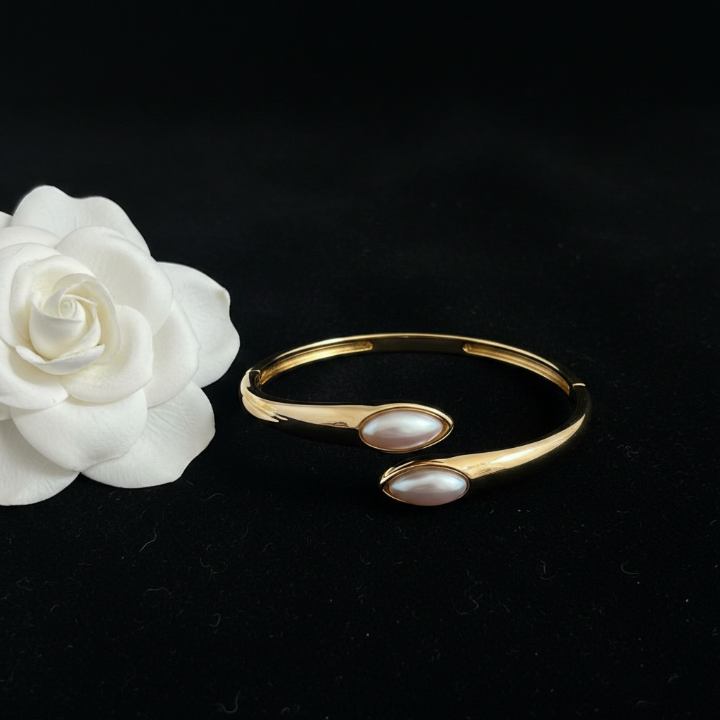 Bypass pearl gold bangle flat lay