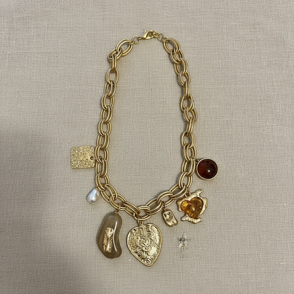 Gold charm necklace flat lay