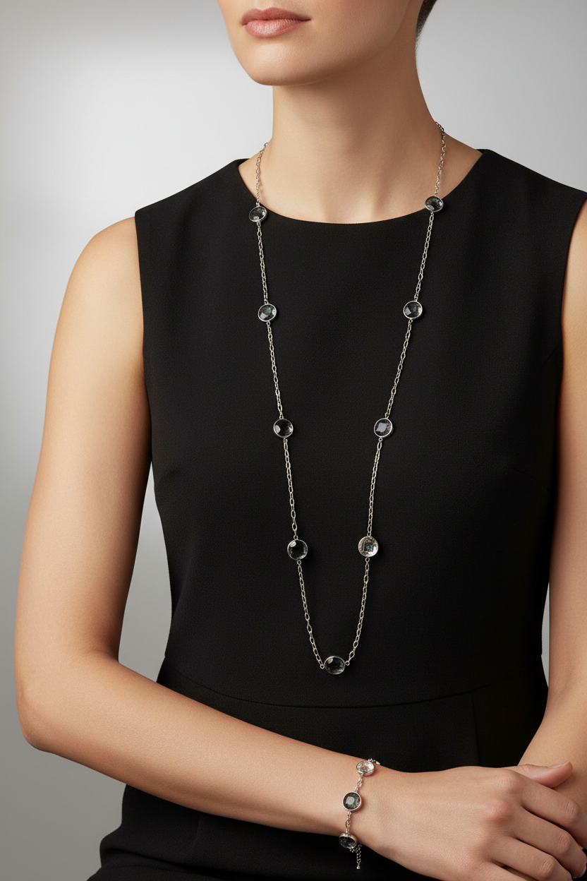 Model wearing silver crystal station necklace and bracelet set