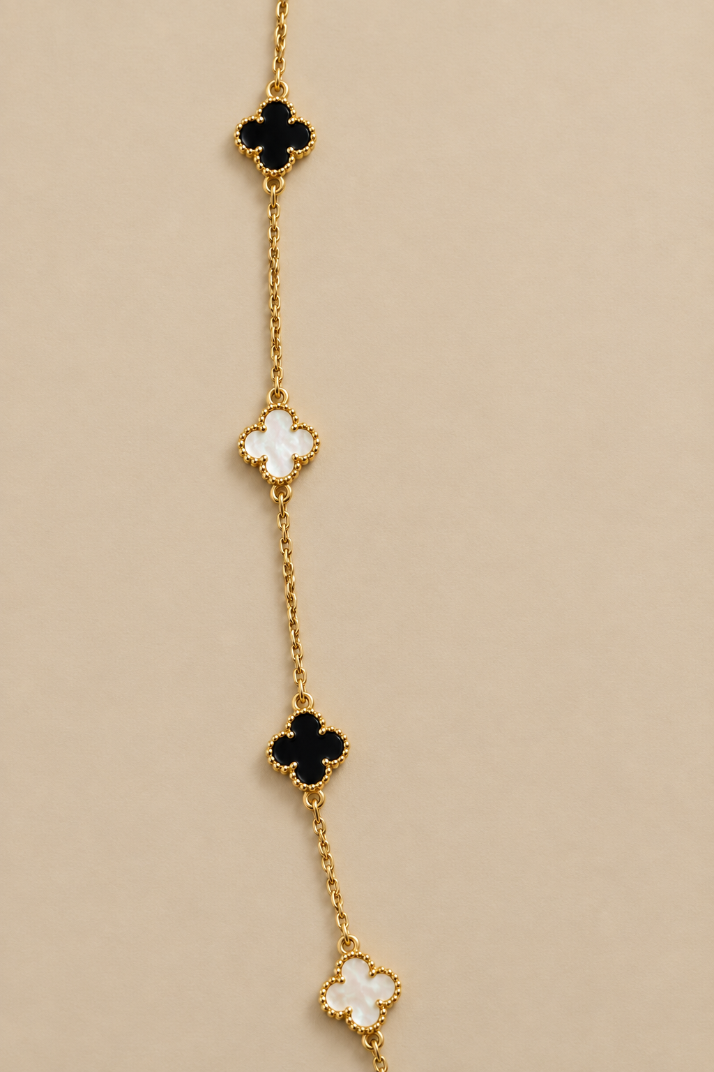 Necklace details on a plain beige background