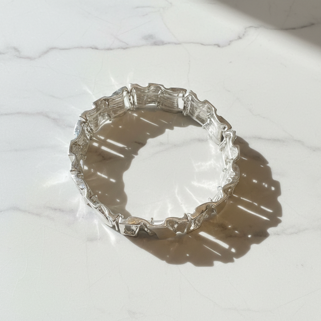 Silver elastic link bracelet white marble flat lay