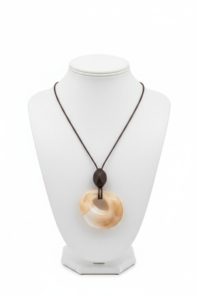 White background cream twisted donut pendant dark cord necklace