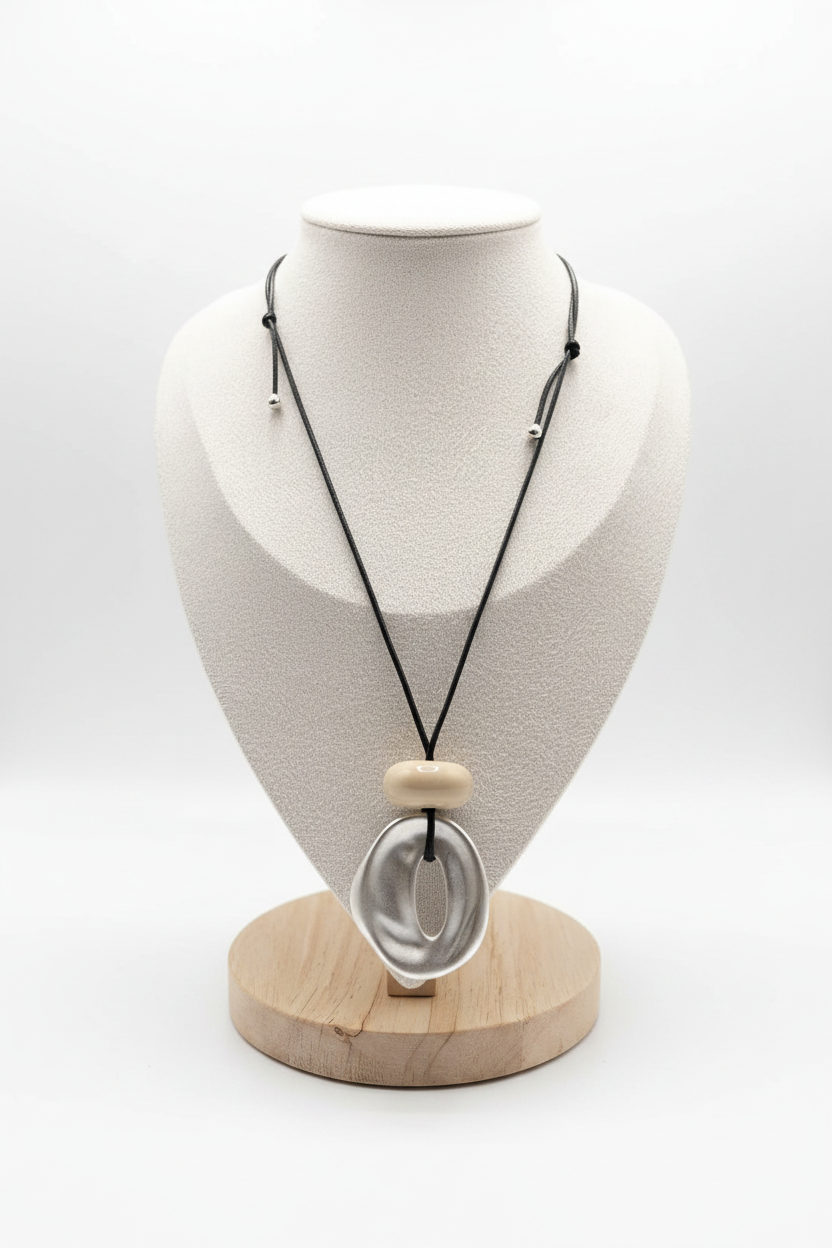 White background pearlescent oval pendant black cord necklace